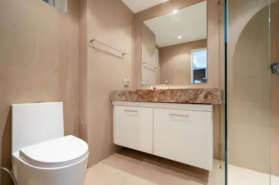 a bathroom with a toilet and a sink and a mirror at Mountain View Apt, High Speed Internet - 1BR-Karon in Kata Beach