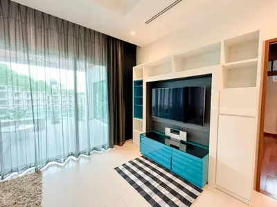 a living room with a tv and a large window at Kamala Falls A3-4 IBG Property in Kamala Beach