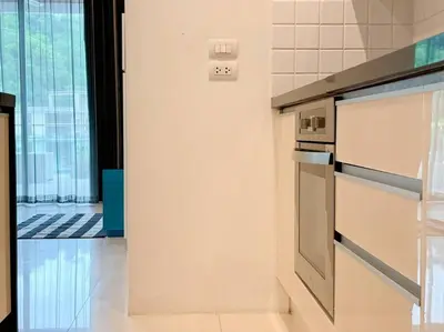 a kitchen with a refrigerator and a stove top oven at Kamala Falls A3-4 IBG Property in Kamala Beach