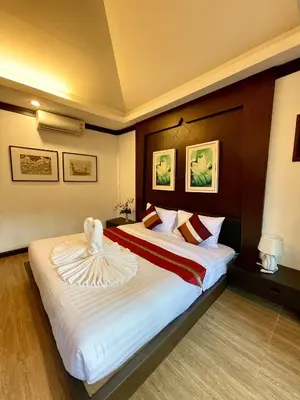 a hotel room with a bed with a towel on it at Fullmoon Beachresort Krabi in Ao Nang Beach