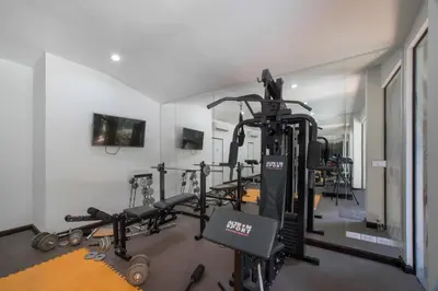 a gym with several tread machines in a room at NOVA Condo 1BR Pool View NBC Nai Harn in Rawai Beach
