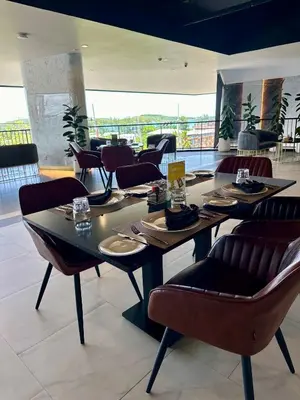 a dining room with tables and chairs in a restaurant at Duplex Luxury Apartments in 5 Star Hotel in Rawai Beach