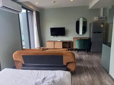 a room with a bed and a desk and a television at The Deck Patong 7Fl Mountain View2 in Patong Beach