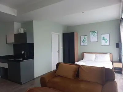 a living room with a couch and a bed at The Deck Patong 7Fl Mountain View2 in Patong Beach