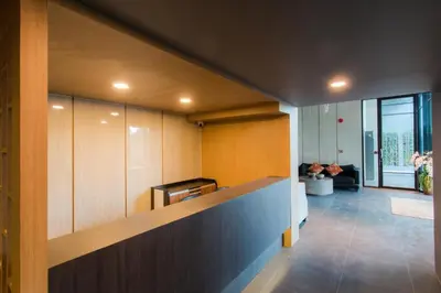 a room with a counter and a living room at 6th Avenue Surin Condomium in Surin Beach