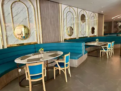 a dining room with tables and chairs and mirrors at Apartment 5 Star Hotel LaVita in Rawai Beach