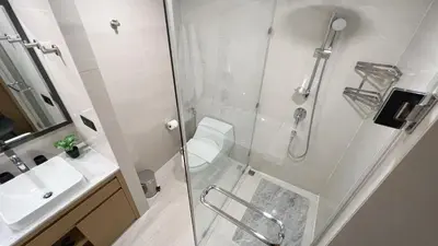 a bathroom with a shower and a toilet and a sink at Apartment 5 Star Hotel LaVita in Rawai Beach