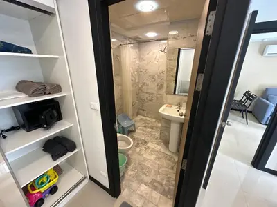 a small bathroom with a toilet and a sink at 1 - Bedroom Apartment Pool Access, 750m to the Beach in Mai Khao Beach