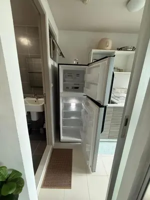 a kitchen with an open refrigerator and a sink at D-Condo Mine Kathu in Ban Ket Ho