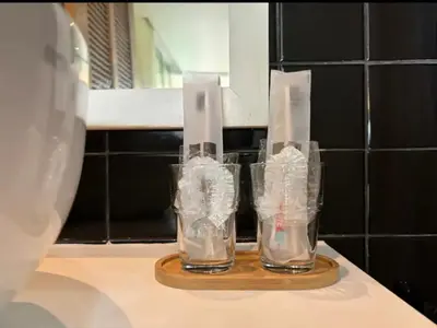 two empty glasses sitting on a counter in a kitchen at มัณดาวีต์ คอนโดa in Ban Khlong Son