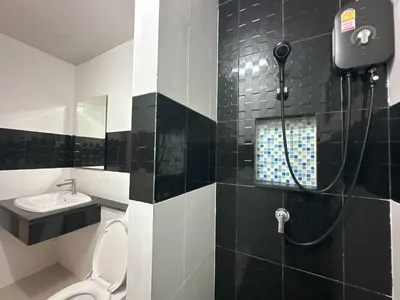 a bathroom with a shower with a toilet and a sink at Blue Horizon Hostel By Blue Flow in Phi Phi Don