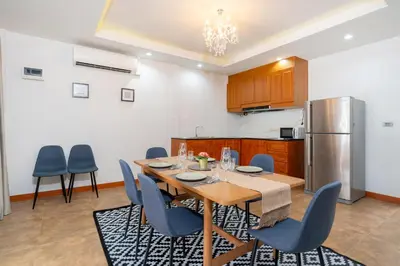 a kitchen with a table and chairs and a refrigerator at Patong private home 4BR Jazzuci sleep 10 in Patong Beach