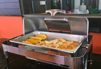 a tray of pastries and other food in a buffet at Rattana Karon Beach Hotel in Karon Beach