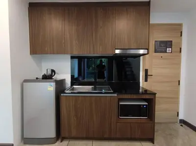 a small kitchen with a sink and a refrigerator at Utopia Naiharn - Room3 - B124 in Rawai Beach