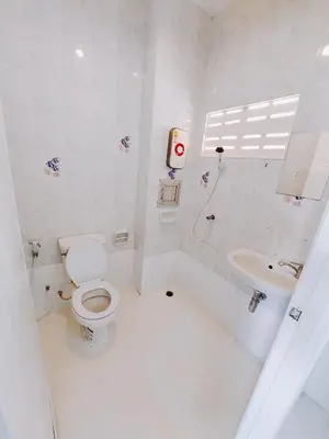 a white bathroom with a toilet and a sink at XX Bao Patong Beach PHUKET เบา หาดป่าตอง ภูเก็ต in Patong Beach