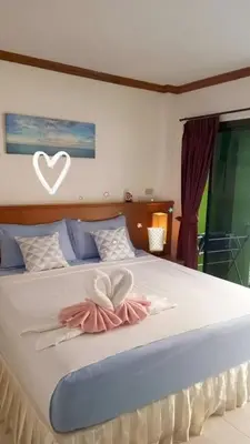a bedroom with a bed with a heart on it at Kata Goran in Kata Beach