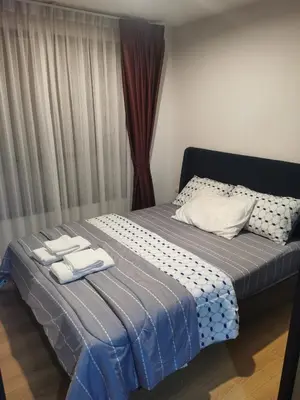 a bedroom with a bed with two towels on it at Centrio Phuket C3 in Ban Rangeng