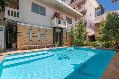 a swimming pool in front of a house at Centre Point Nanai in Patong Beach