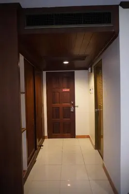 a hallway with two doors and a tile floor at Centre Point Nanai in Patong Beach