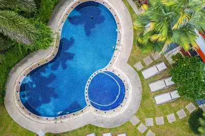 an overhead view of a large swimming pool at Cozy 1BR Poolside Apartment with Scenic Balcony C132 in Surin Beach