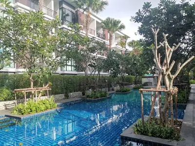 a swimming pool in front of a building at Rawai Beachfront - Studio room on 2 floor in Rawai Beach