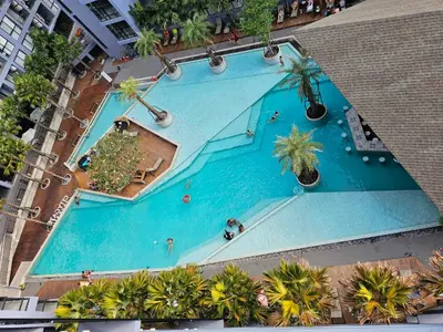 an overhead view of a large swimming pool with palm trees at 1BDR 2 Pools on the roof 500m to beach 3 Bars in Kamala Beach