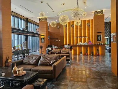 a lobby with couches and a bar in a building at 1BDR 2 Pools on the roof 500m to beach 3 Bars in Kamala Beach