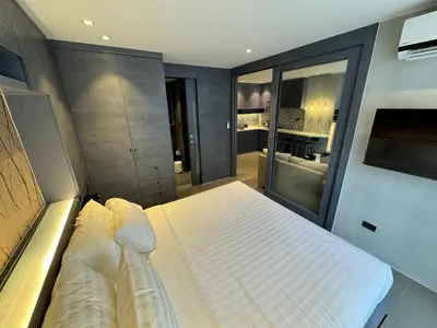 a bedroom with a large bed in a room at 1BDR 2 Pools on the roof 500m to beach 3 Bars in Kamala Beach