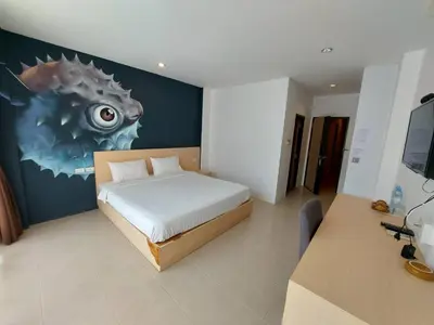 a bedroom with a bed with a painting on the wall at xx GO INN Ao Nang Krabi - โกอินน์ อ่าวนาง กระบี่ Aonang in Ban Khlong Haeng