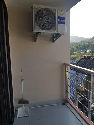 a balcony with a air conditioner on a wall at Rawai beach condominium \u62c9\u8587\u6d77\u6ee9\u9152\u5e97\u516c\u5bd3 in Nai Harn Beach