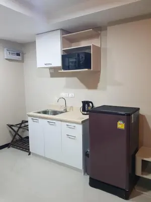 a small kitchen with a sink and a refrigerator at Rawai beach condominium \u62c9\u8587\u6d77\u6ee9\u9152\u5e97\u516c\u5bd3 in Nai Harn Beach