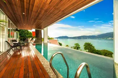 a balcony of a house with a view of the water at Patong WiN HOUSE Villa in Patong Beach