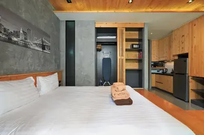 a bedroom with a bed with a teddy bear on it at Relife Windy B226 at NaiHarn beach by CapitalPro in Phuket Town