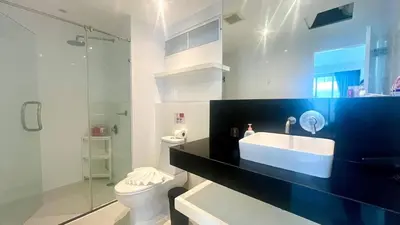 a bathroom with a sink and a toilet and a shower at Sunset Plaza Condominium in Karon Beach