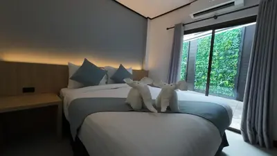 two white teddy bears sitting on top of a bed at Jong's House- Phi Phi Island in Phi Phi Don