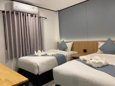 a hotel room with two beds with white sheets at Jong's House- Phi Phi Island in Phi Phi Don