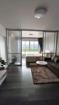 a living room with a bed and a coffee table at Dcondo mine Kathu Phuket in Kathu