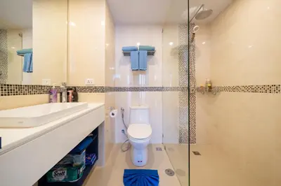 a bathroom with a toilet and a sink and a shower at Allamanda Laguna Phuket in Laguna Phuket