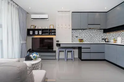a kitchen with a couch and a counter top at Your Relaxing Stay! Suite CTG P506 at Tropics Kamala Residence with Scenic Rooftop Pool and Great Amenities in Kamala Beach