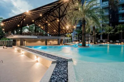 a swimming pool in front of a building at Your Relaxing Stay! Suite CTG P506 at Tropics Kamala Residence with Scenic Rooftop Pool and Great Amenities in Kamala Beach