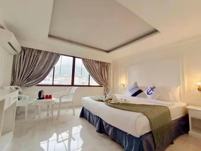 a hotel room with a large bed and a desk at Chilli Salza Patong in Patong Beach