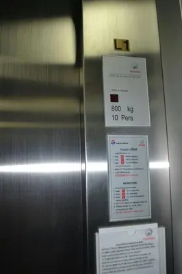 a metal elevator with a sign on it at Absolute Bangla Suites 69sqm with Jacuzzi in Patong Beach