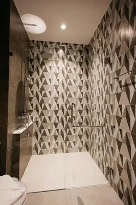 a bathroom with a shower with a tile wall at Halo 1 Title Naiyang beach in Phuket Town