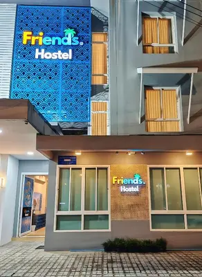 a front view of a hotel with a sign on it at Friends Hostel - Phuket Airport in Nai Yang Beach