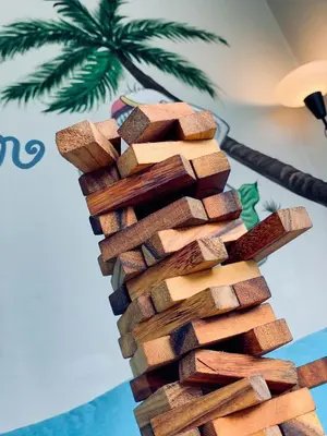 a stack of wine cork towers stacked on a table at Friends Hostel - Phuket Airport in Nai Yang Beach