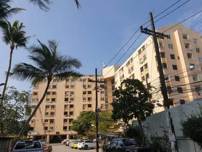 a large building with palm trees in front of it at Monkey Apartment in Patong Beach