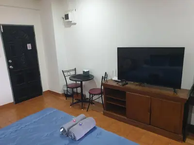 a living room with a flat screen tv on a entertainment center at Monkey Apartment in Patong Beach