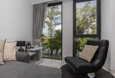 a living room with a couch and a chair at Cassia 1BR City View apt by NLA in Bang Tao Beach