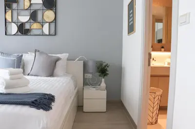 a bedroom with a white bed and a mirror at Cassia 1BR City View apt by NLA in Bang Tao Beach