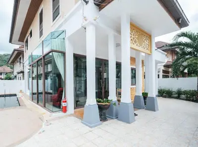 a building with columns and windows and a fire hydrant at Pool Villa Tambon Patong in Patong Beach